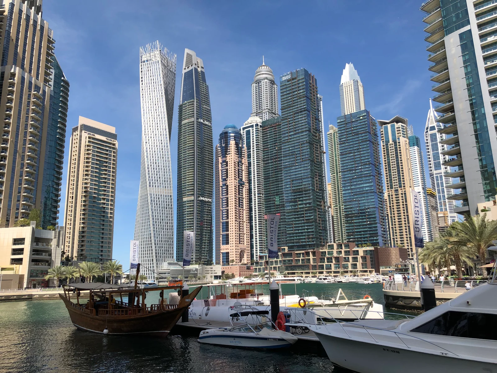 Dubai Marina waterfront with boats, promenade and residential towers, February 2020